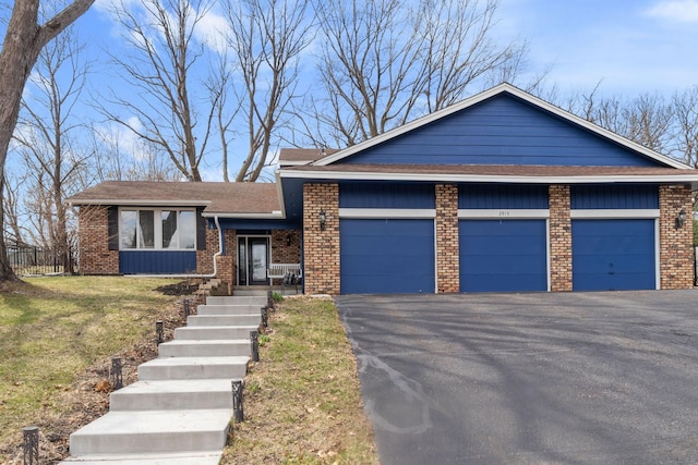 2915 Alvarado Ln N, Plymouth, MN 55447 - view of front of property featuring brick siding, an attached garage, a front lawn, a shingled roof, and driveway