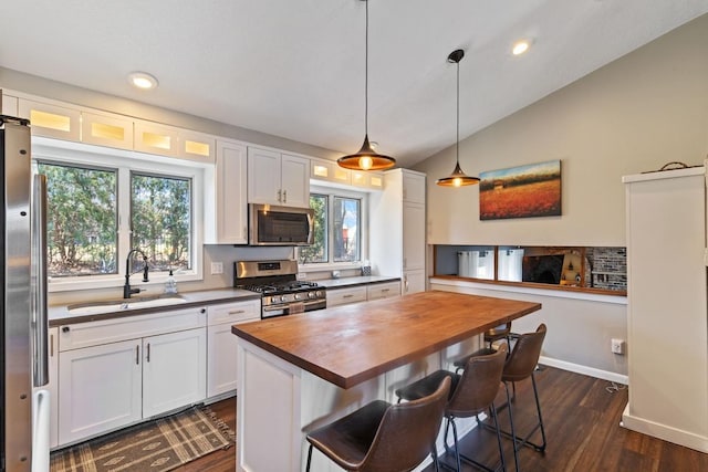 2915 Alvarado Ln N, Plymouth, MN 55447 - kitchen featuring butcher block countertops, appliances with stainless steel finishes, a sink, dark wood-type flooring, and white cabinetry