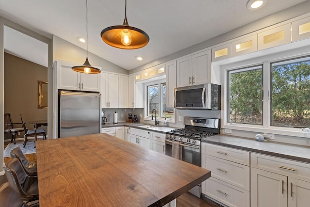 2915 Alvarado Ln N, Plymouth, MN 55447 - kitchen with stainless steel appliances, a sink, wooden counters, white cabinetry, and vaulted ceiling