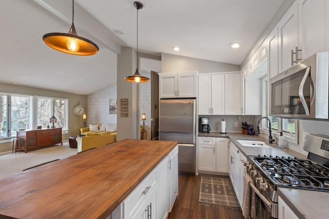 2915 Alvarado Ln N, Plymouth, MN 55447 - kitchen with wood counters, appliances with stainless steel finishes, a sink, open floor plan, and white cabinets