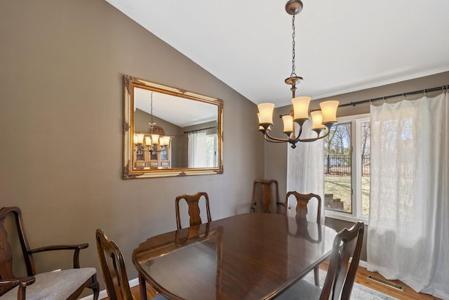 2915 Alvarado Ln N, Plymouth, MN 55447 - dining room featuring a chandelier, lofted ceiling, healthy amount of natural light, and baseboards