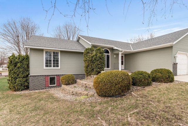 ranch-style home featuring a front lawn, a shingled roof, an attached garage, and concrete driveway