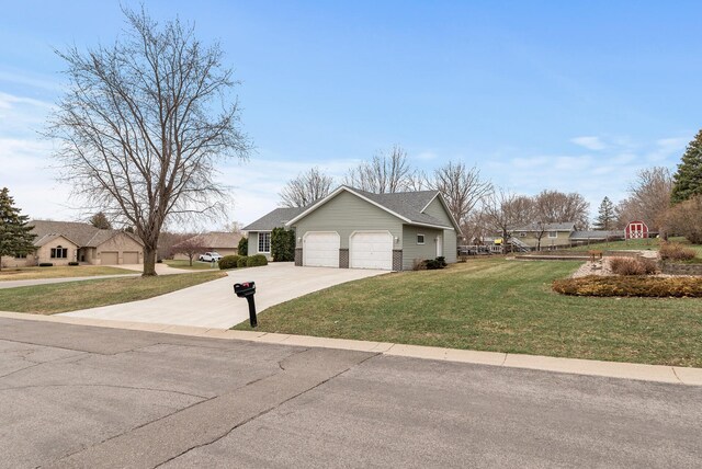view of front of house featuring concrete driveway, a front yard, and an attached garage