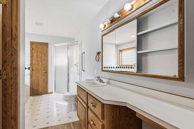 bathroom with vanity, a stall shower, tile patterned floors, toilet, and visible vents