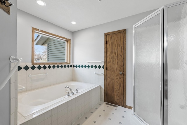 full bathroom featuring a bath, a shower stall, and recessed lighting