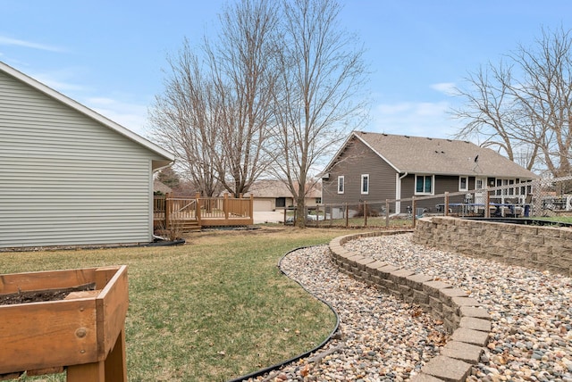 view of yard featuring a deck and fence
