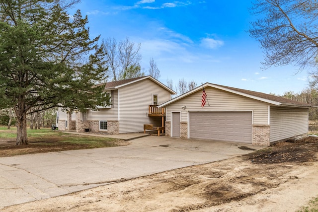 view of front of house featuring brick siding, a garage, and concrete driveway