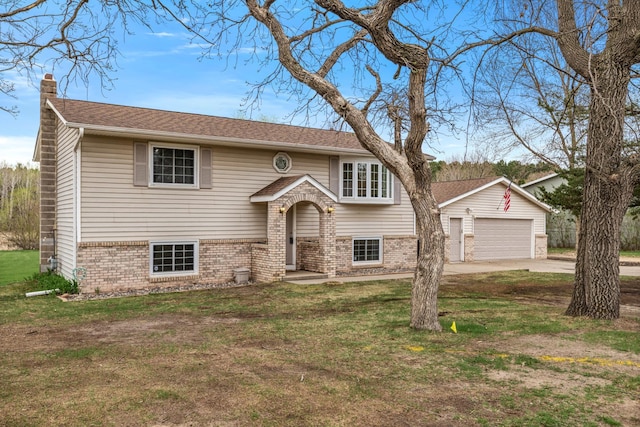 bi-level home with brick siding, a chimney, and a front yard