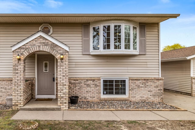 doorway to property with brick siding