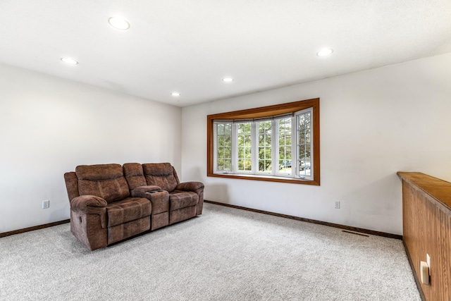 living room with carpet floors, baseboards, and recessed lighting