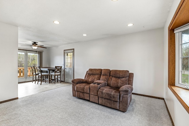 carpeted living area featuring recessed lighting, baseboards, a ceiling fan, and a wealth of natural light