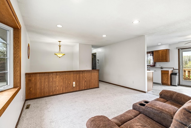 living room featuring recessed lighting, baseboards, visible vents, and light carpet