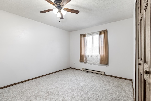 carpeted spare room featuring baseboards, a baseboard radiator, a ceiling fan, and a textured ceiling