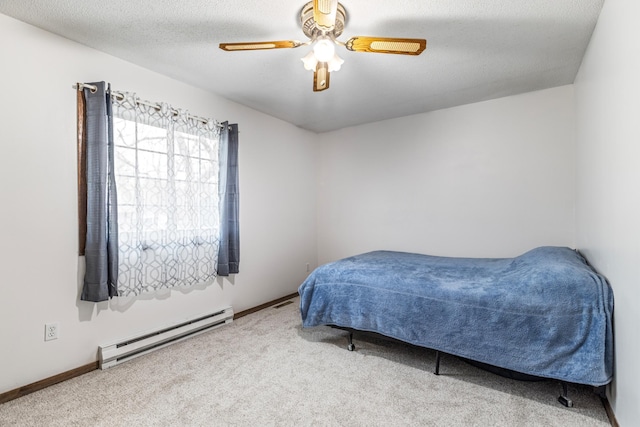 bedroom with carpet, baseboards, baseboard heating, and a ceiling fan