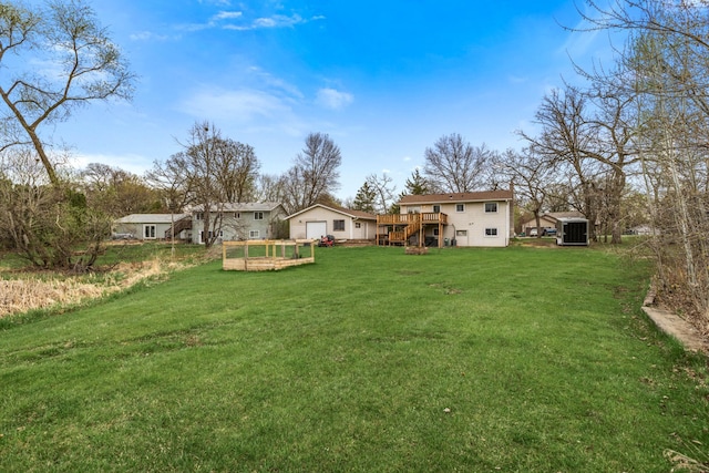 view of yard featuring a shed, stairs, an outbuilding, and a deck