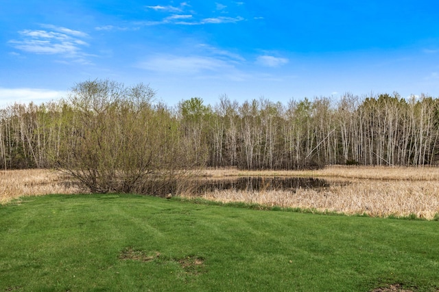 view of landscape featuring a forest view
