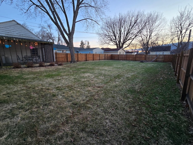 1014 3rd Ave SW, Pipestone, MN 56164 - yard at dusk with a fenced backyard