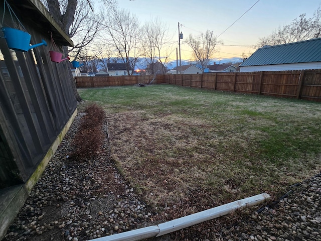 1014 3rd Ave SW, Pipestone, MN 56164 - yard at dusk with a fenced backyard