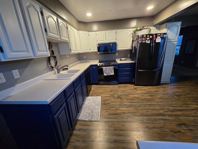 1014 3rd Ave SW, Pipestone, MN 56164 - kitchen with a sink, freestanding refrigerator, dark wood-style floors, blue cabinetry, and electric range