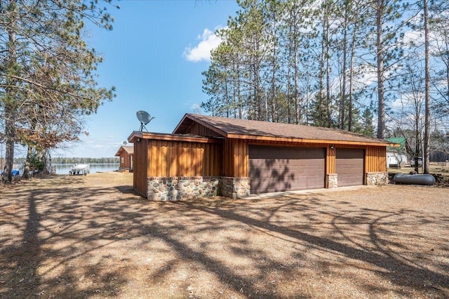detached garage featuring a water view