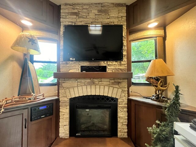 living room featuring a fireplace and a wealth of natural light