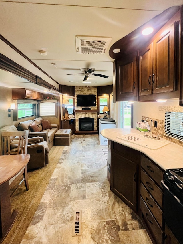 kitchen with open floor plan, a healthy amount of sunlight, a sink, and visible vents