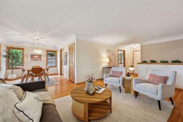 9017 31st St, Saint Louis Park, MN 55426 - living room with light wood finished floors and a chandelier