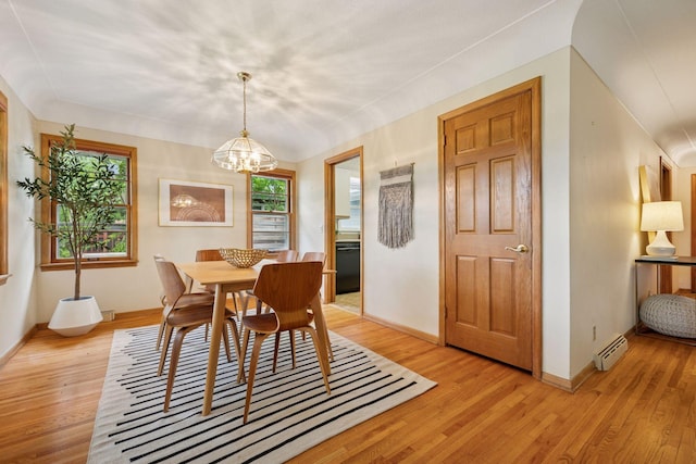 9017 31st St, Saint Louis Park, MN 55426 - dining area with a baseboard heating unit, a chandelier, and light wood-style flooring