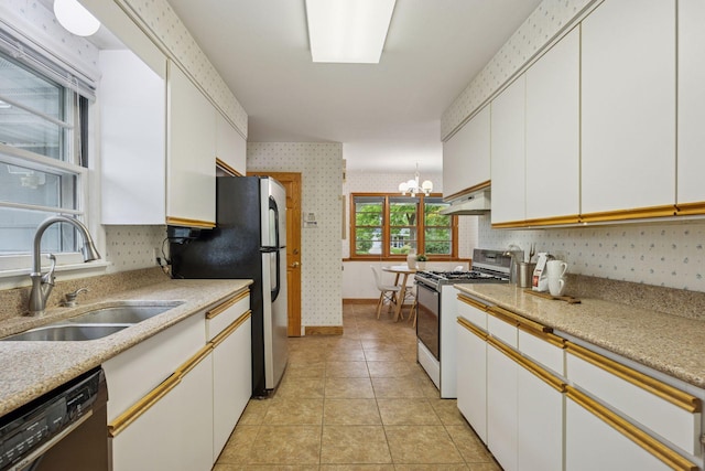 9017 31st St, Saint Louis Park, MN 55426 - kitchen with white range with gas cooktop, black dishwasher, wallpapered walls, a chandelier, and light countertops