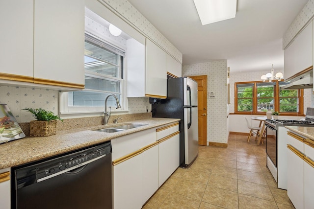 9017 31st St, Saint Louis Park, MN 55426 - kitchen featuring gas range oven, black dishwasher, wallpapered walls, white cabinetry, and freestanding refrigerator