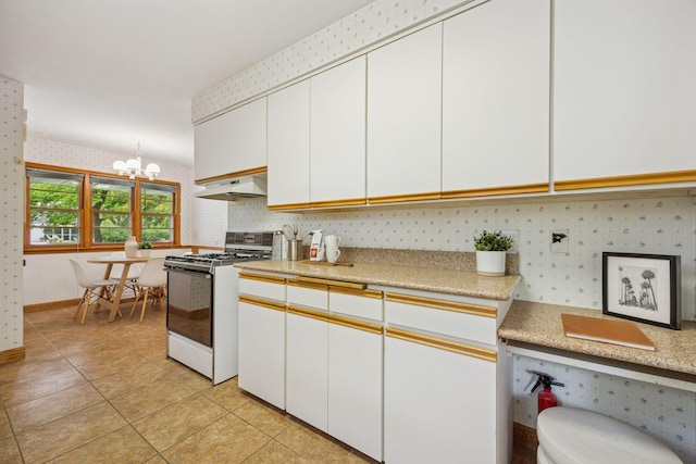 9017 31st St, Saint Louis Park, MN 55426 - kitchen featuring gas range gas stove, exhaust hood, wallpapered walls, light countertops, and a chandelier