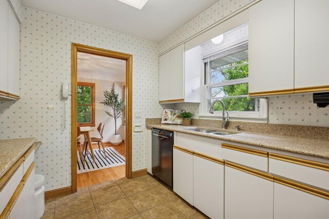 9017 31st St, Saint Louis Park, MN 55426 - kitchen with dishwasher, wallpapered walls, light countertops, white cabinetry, and light tile patterned floors
