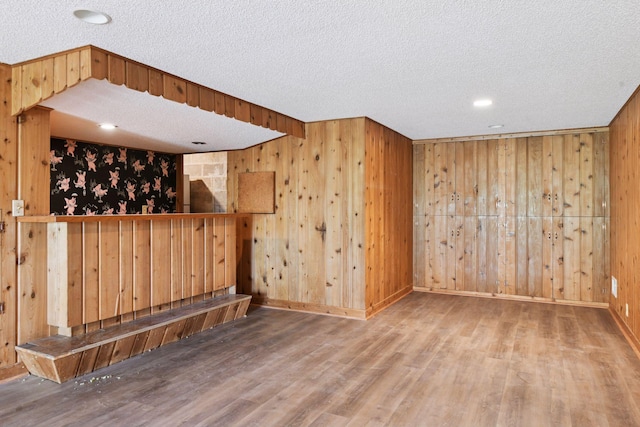 9017 31st St, Saint Louis Park, MN 55426 - bar area featuring wood walls, wood finished floors, a textured ceiling, and recessed lighting