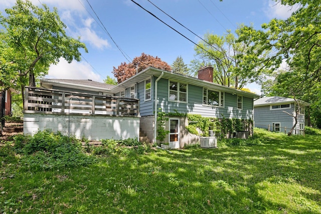9017 31st St, Saint Louis Park, MN 55426 - rear view of house with a chimney and a lawn
