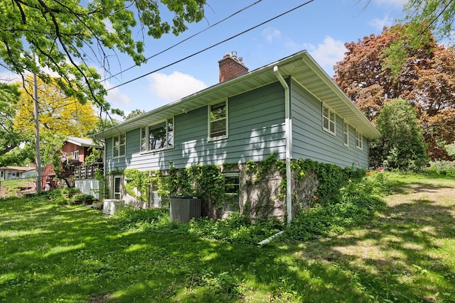 9017 31st St, Saint Louis Park, MN 55426 - view of side of home with a chimney and a lawn