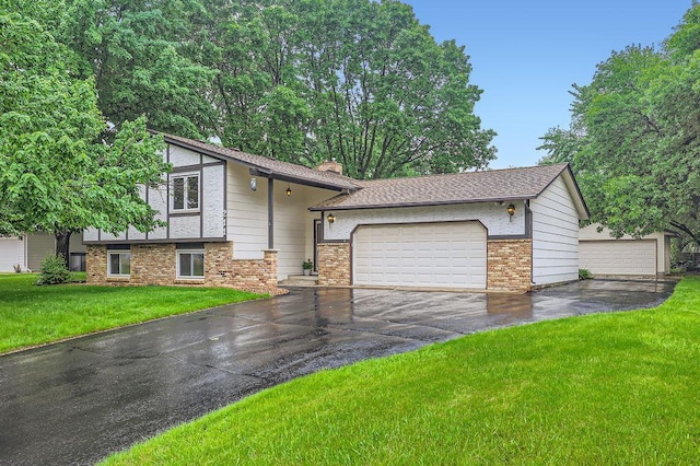 211 Mckinley St, Anoka, MN 55303 - split level home with a chimney, a front lawn, brick siding, and concrete driveway