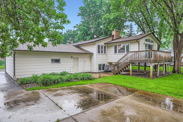 211 Mckinley St, Anoka, MN 55303 - rear view of property with stairway, a yard, a chimney, a patio area, and a wooden deck