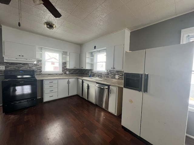kitchen with white refrigerator with ice dispenser, black electric range oven, under cabinet range hood, stainless steel dishwasher, and a sink