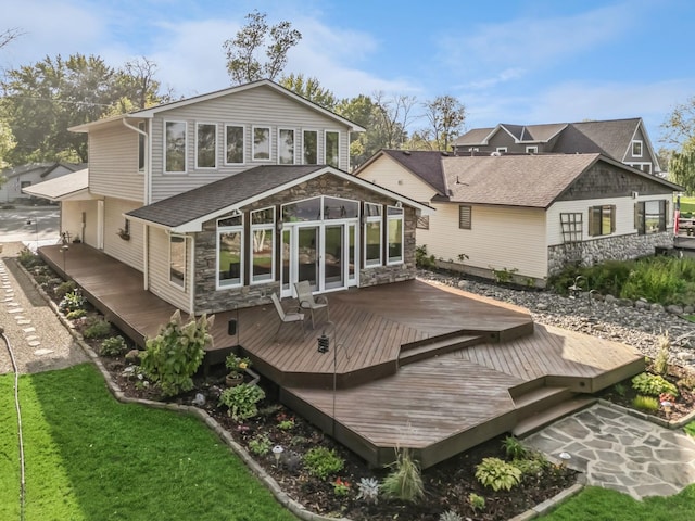 1867 Beach Dr SE, Forest Lake, MN 55025 - back of property featuring a deck, stone siding, and a sunroom