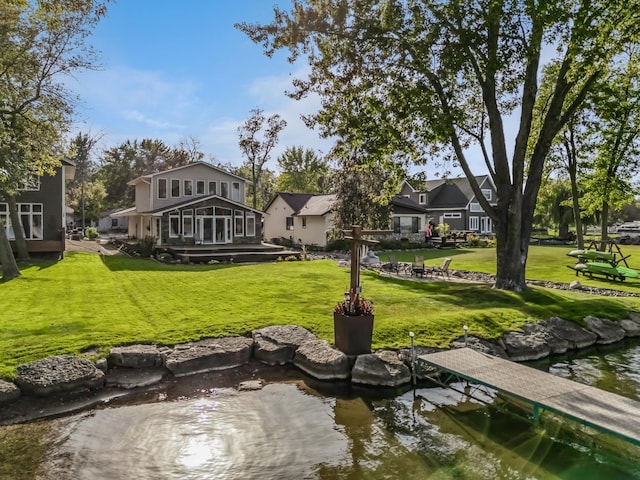 1867 Beach Dr SE, Forest Lake, MN 55025 - view of property's community with a lawn, a boat dock, and a residential view