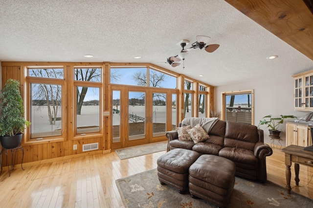 1867 Beach Dr SE, Forest Lake, MN 55025 - living area featuring a ceiling fan, a textured ceiling, hardwood / wood-style flooring, a water view, and lofted ceiling