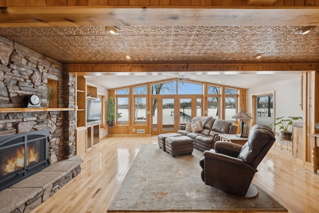 1867 Beach Dr SE, Forest Lake, MN 55025 - living room with an ornate ceiling, hardwood / wood-style flooring, a stone fireplace, and lofted ceiling