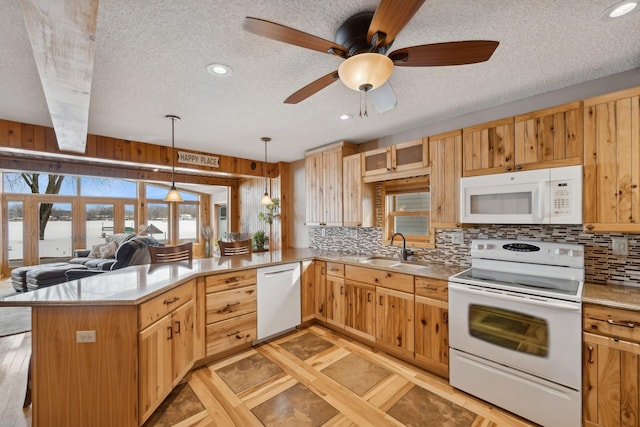 1867 Beach Dr SE, Forest Lake, MN 55025 - kitchen with white appliances, a sink, a peninsula, a textured ceiling, and tasteful backsplash