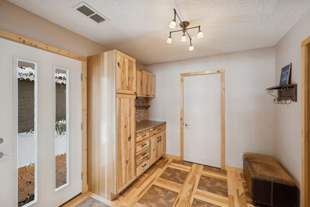 1867 Beach Dr SE, Forest Lake, MN 55025 - mudroom with a textured ceiling and baseboards