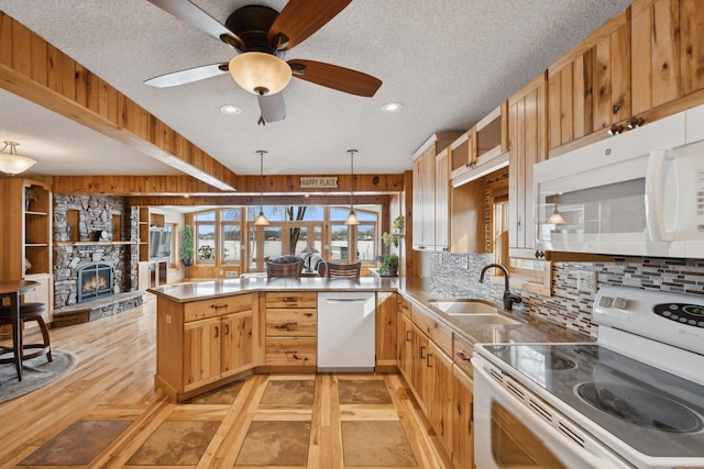 1867 Beach Dr SE, Forest Lake, MN 55025 - kitchen featuring white appliances, a peninsula, a sink, a textured ceiling, and a fireplace