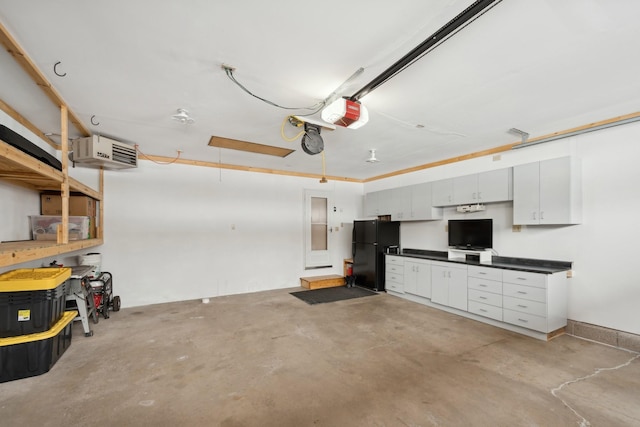 1867 Beach Dr SE, Forest Lake, MN 55025 - garage featuring freestanding refrigerator, a garage door opener, and a heating unit