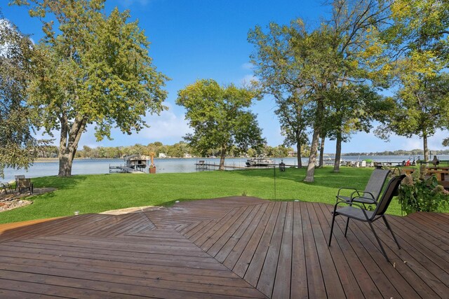 1867 Beach Dr SE, Forest Lake, MN 55025 - wooden terrace with a water view, a lawn, and a boat dock