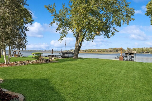 1867 Beach Dr SE, Forest Lake, MN 55025 - view of green lawn with a water view and a boat dock