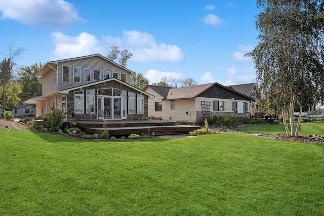 1867 Beach Dr SE, Forest Lake, MN 55025 - rear view of property with stone siding, a wooden deck, and a lawn