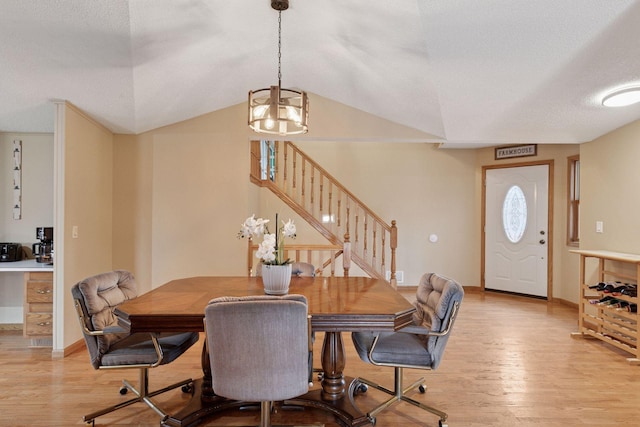34115 Malmberg Ave, Chisago Lake Twp, MN 55045 - dining area with light wood finished floors, stairway, a chandelier, a textured ceiling, and vaulted ceiling